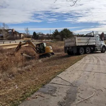 Excavator and truck at site