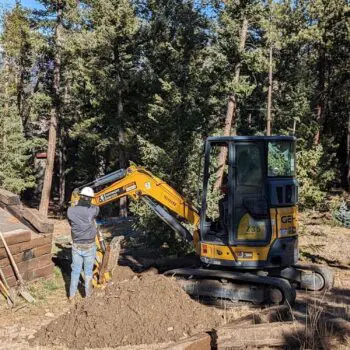 Excavator digging forest construction site