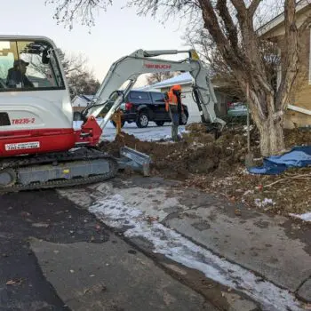 Excavator digging residential construction site