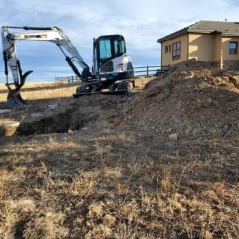 Excavator digging near residential property