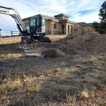 Excavator digging residential construction site