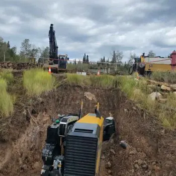 Excavator digging large construction site