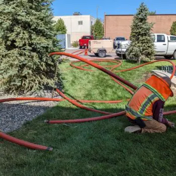 Construction worker outdoor pipe installation