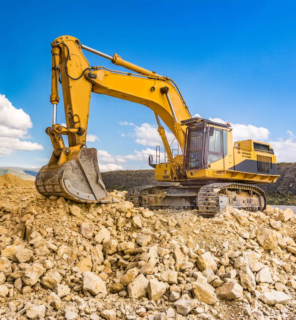 Excavator digging rocky terrain