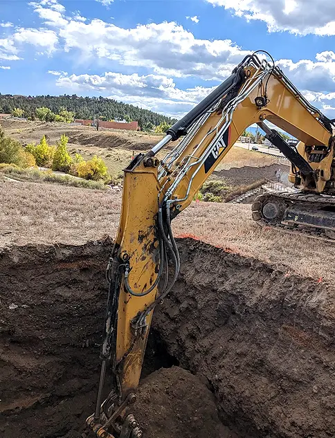 Excavator performing trench digging