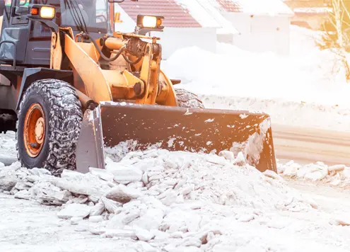 Snow plow clearing snowy road