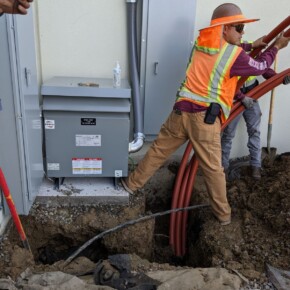 Construction worker installing electrical cables
