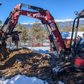 Excavator digging in snowy ground