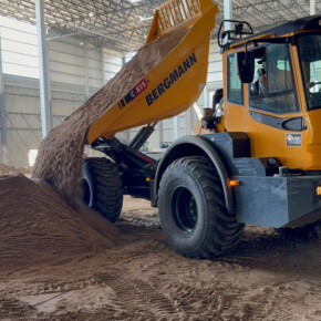 Dump truck unloading soil indoors