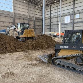 Construction vehicles inside industrial building