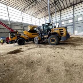 Construction vehicles inside large building
